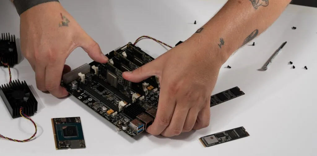 RK1 compute module being inserted into Turing Pi 2.5 slot